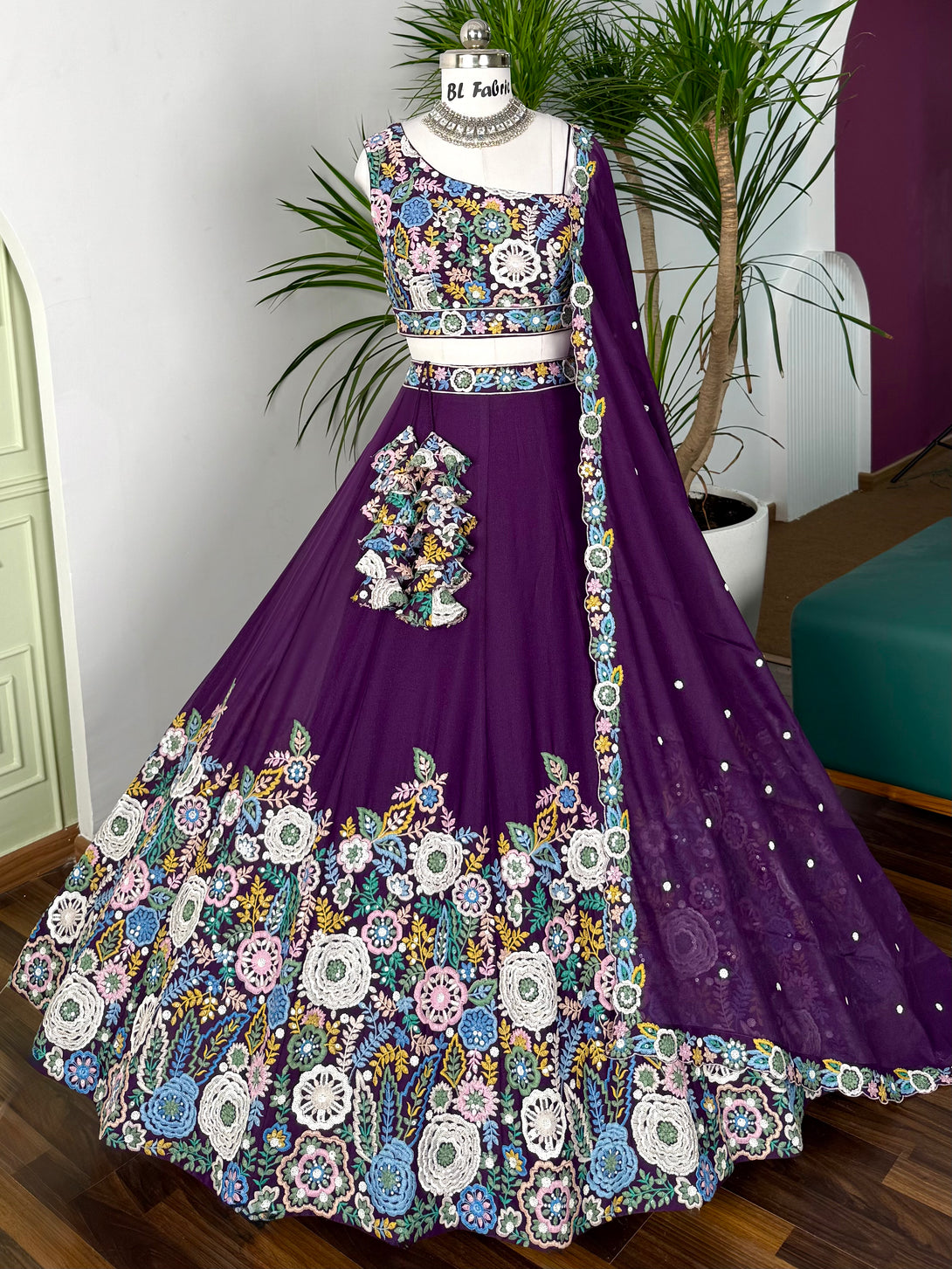 Purple embroidered lehenga with matching blouse on a mannequin against a neutral background.